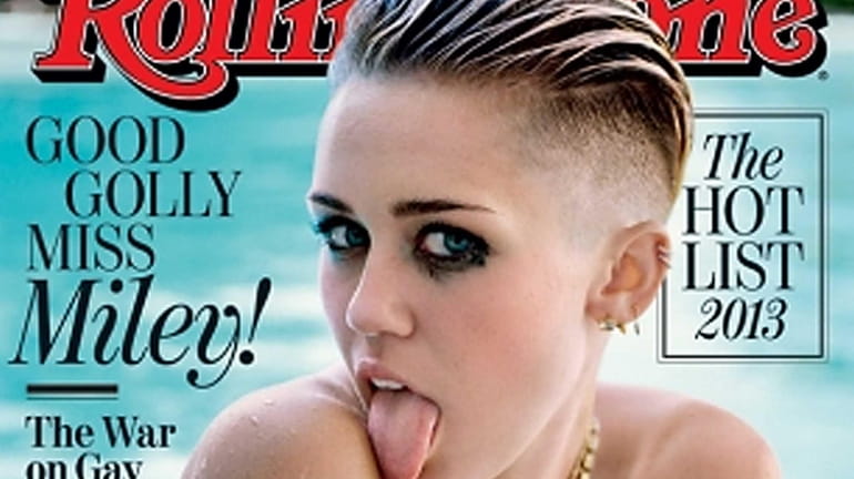 Miley Cyrus poses topless on the cover of the Oct....