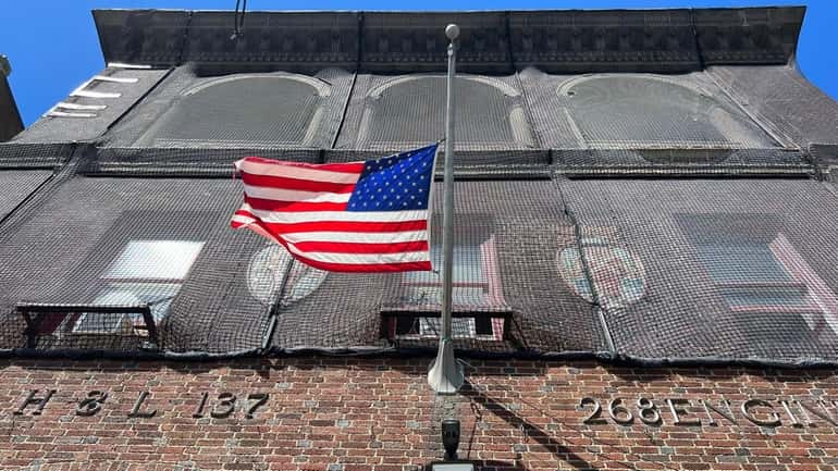 The flag is at half-staff at the FDNY Ladder 137,...