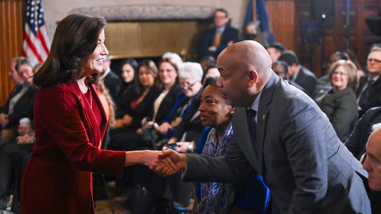Gov. Kathy Hochul greets Assembly Speaker Carl Heastie (D-Bronx) in the Red Room...