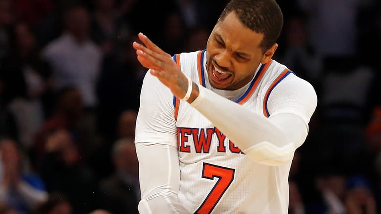 Carmelo Anthony, #7, of the New York Knicks reacts after...