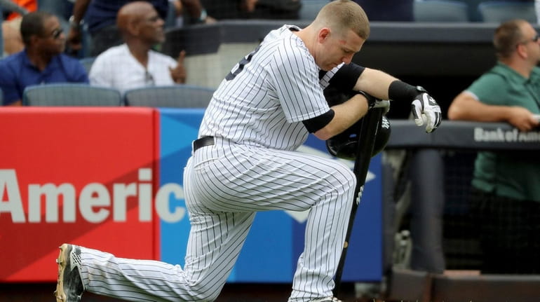 Todd Frazier of the Yankees reacts after a child was...