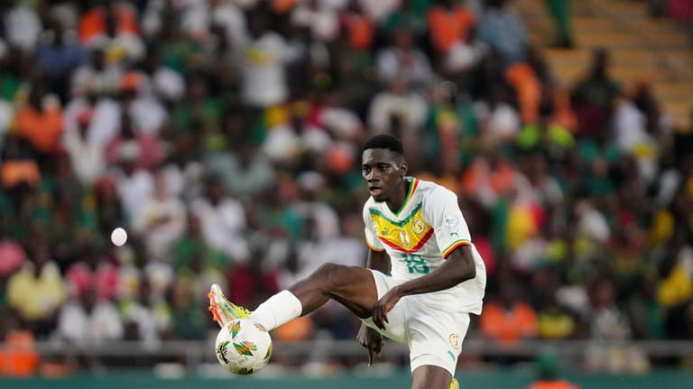 Senegal's Ismaila Sarr jumps for the ball during the African...