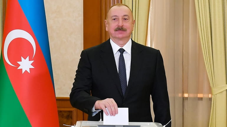 Azerbaijan President Ilham Aliyev casts his ballot during presidential election...