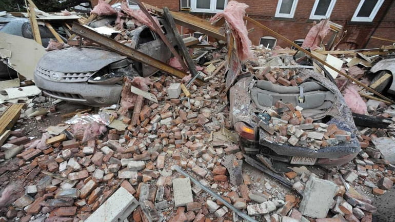 Bricks and debris that fell from a building lay on...