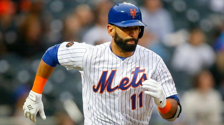Jose Bautista of the Mets runs out a double in...