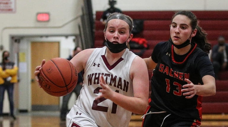 Whitman's Iris Hoffman drives to the basket and past Abby...