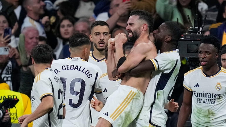 Real Madrid's Dani Carvajal celebrates with teammates after scoring his...
