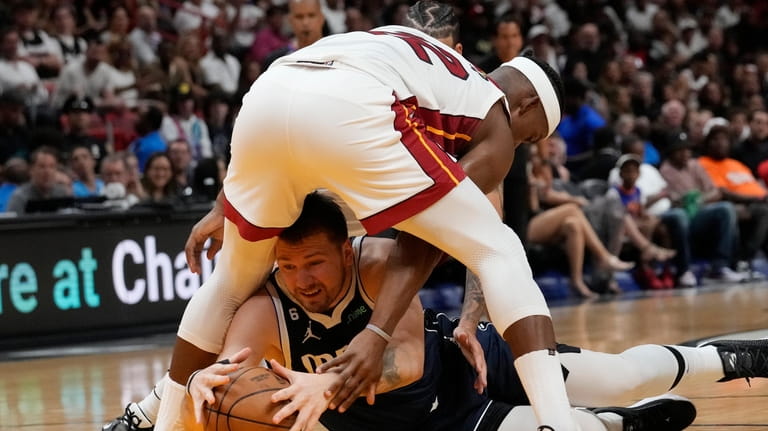 Miami Heat forward Jimmy Butler (22) and Dallas Mavericks guard...
