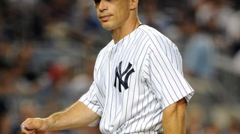 Yankees manager Joe Girardi returns to the dugout after taking...