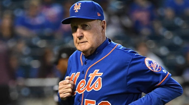 New York Mets pitching coach Phil Regan runs to the...