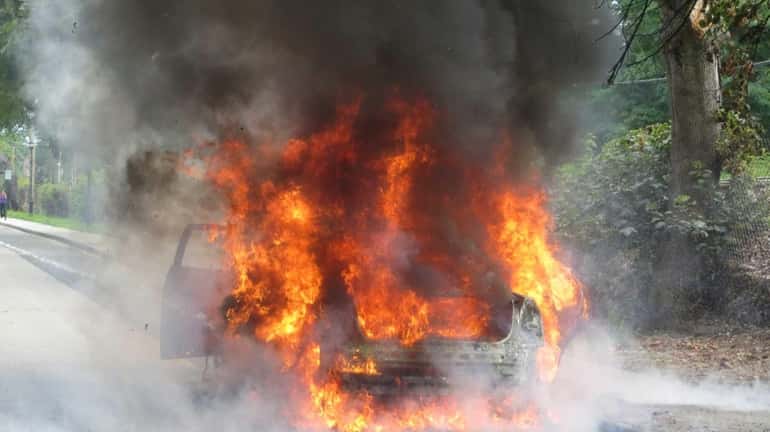 Flames destroy a car on Forest Avenue in Lynbrook on...