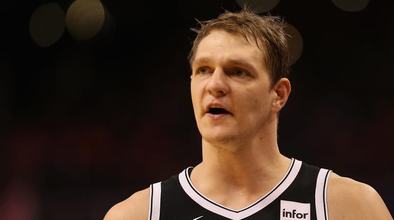 Timofey Mozgov #20 of the Brooklyn Nets reacts after fouling...