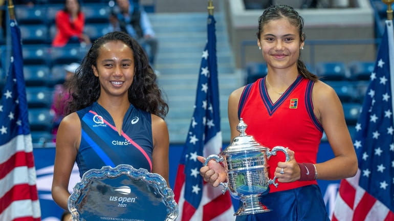 Leylah Fernandez, left, and Emma Raducanu pose with their trophies after the U.S....