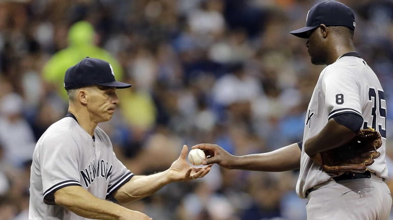 New York Yankees starting pitcher Michael Pineda, right, hands the...