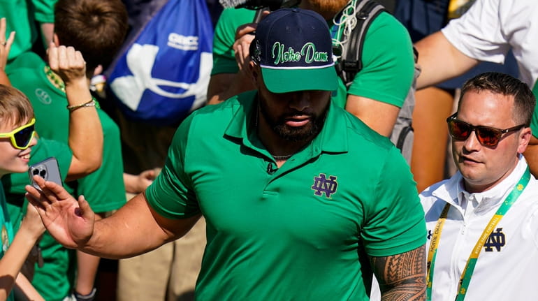 Former Notre Dame player Manti Te'o follows members of the...