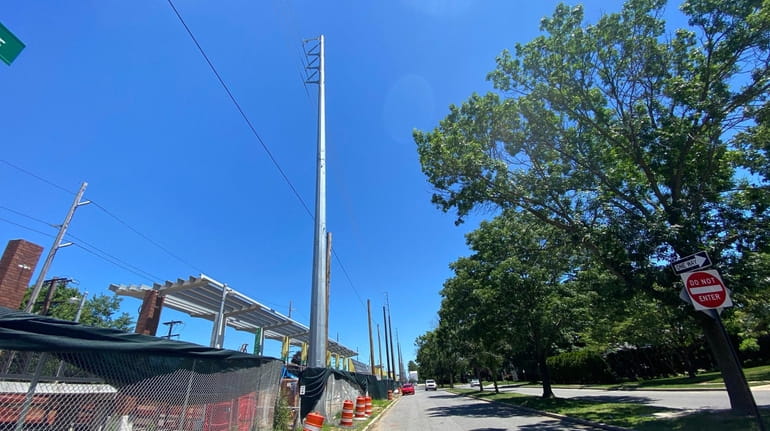 Large steel poles beside the Merillon Avenue LIRR station in...