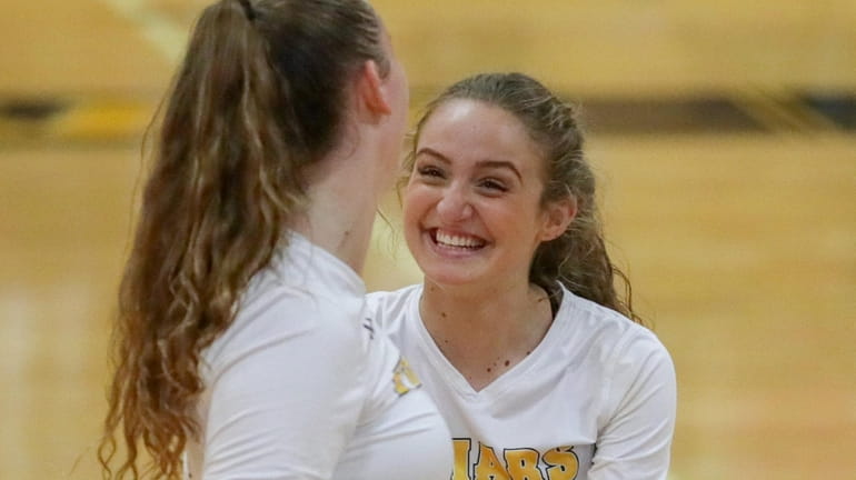 St. Anthony's Sofia Termini, right, is excited about a point with Emma...