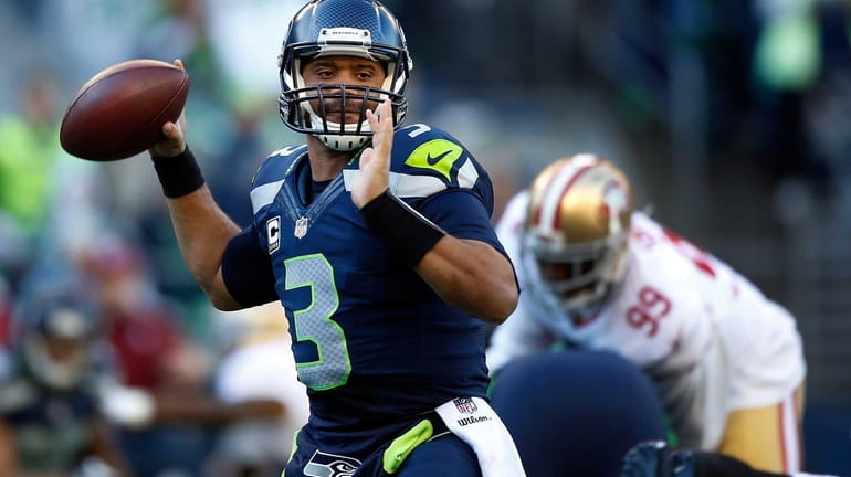 Quarterback Russell Wilson #3 of the Seattle Seahawks throws the...
