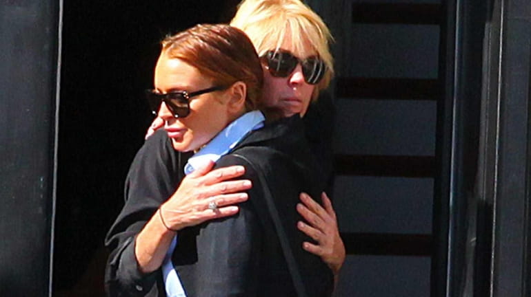 Lindsay and Dina Lohan share a hug outside their home...