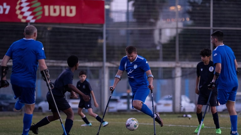 Israel Amputee Football Team player, Ben Binyamin, center, prepares to...