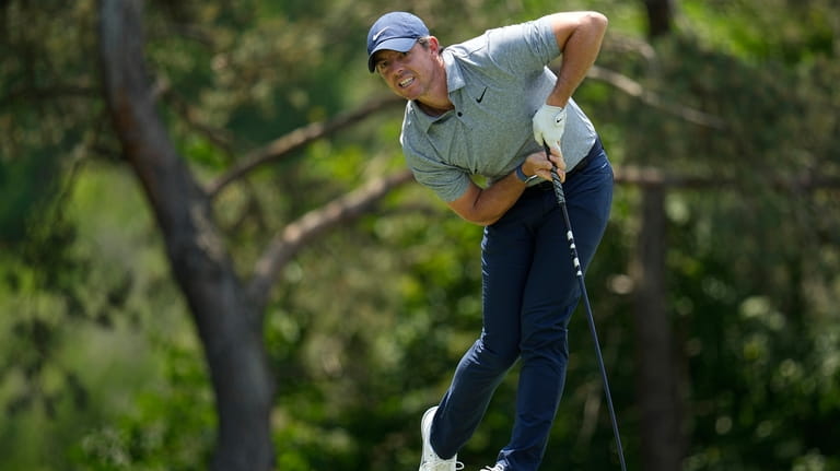 Rory McIlroy, of Northern Ireland, watches his tee shot on...