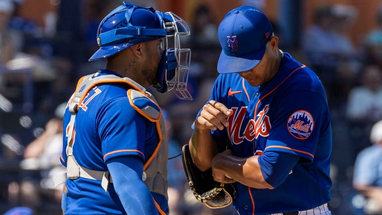 Mets catcher Omar Narvaez talks with pitcher Jose Quintana during a...