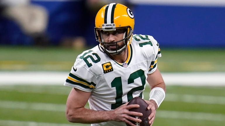 Green Bay Packers quarterback Aaron Rodgers looks to throw during...