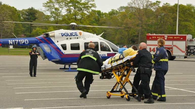 Emergency medical personnel from the Dix Hills Fire Rescue Squad...