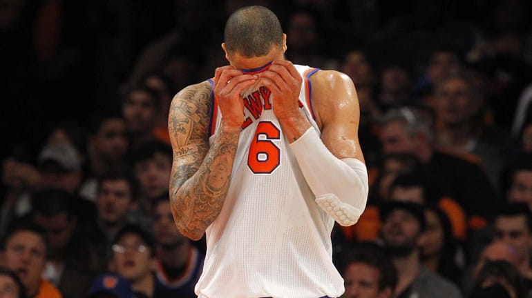 Tyson Chandler wipes his face in the second half of...