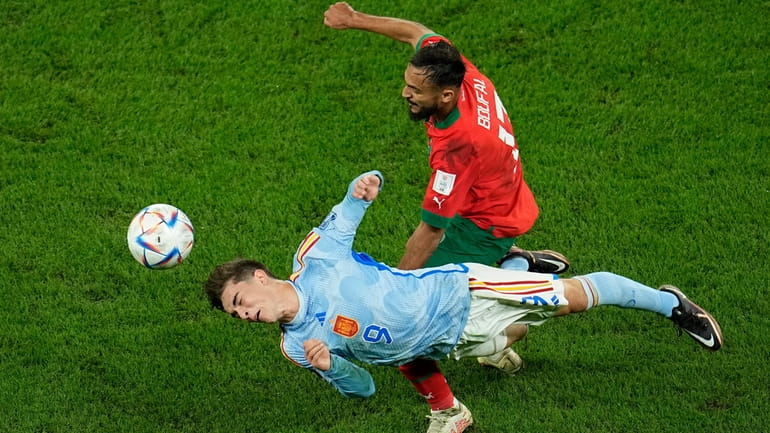 Morocco's Sofiane Boufal in action against Spain's Gavi, bottom, during...