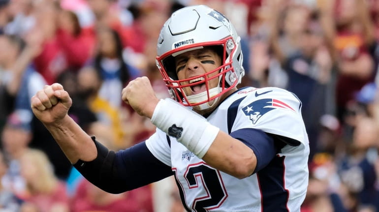 Patriots quarterback Tom Brady reacts to a touchdown against the Redskins...