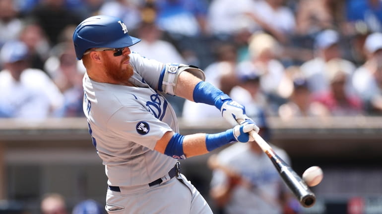 FILE - Los Angeles Dodgers' Justin Turner hits a solo...