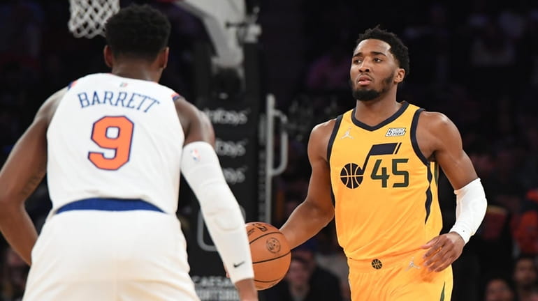 Utah Jazz guard Donovan Mitchell is defended by Knicks guard RJ...