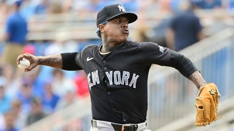 Marcus Stroman of the Yankees delivers a pitch to the Blue...