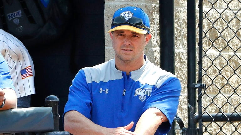 NYIT head coach Frank Catalanotto gives signals from the dugout...