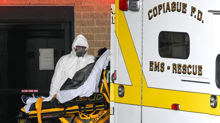 A paramedic in a hazmat suit from the Copiague F.D....