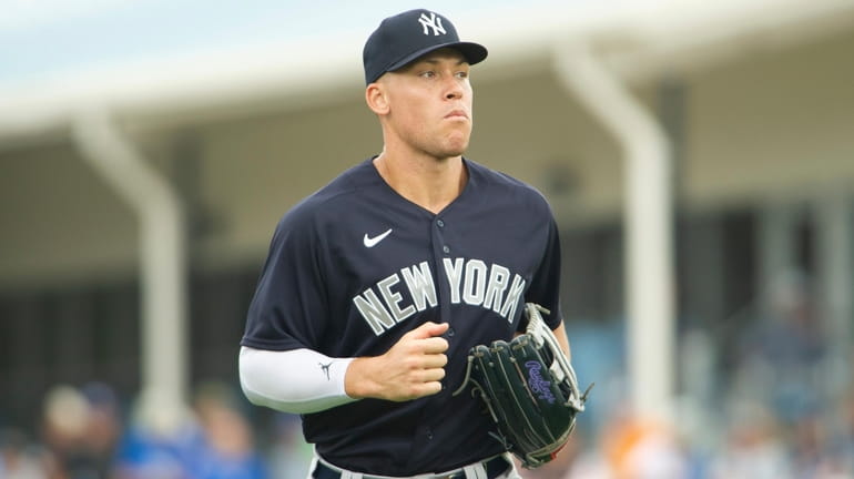 The Yankees' Aaron Judge runs off the field during a...