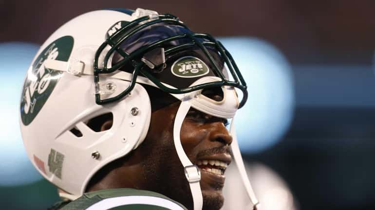 Michael Vick looks on from the bench in the second...