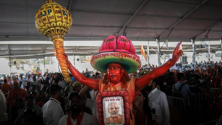 A supporter of India's ruling Bharatiya Janata Party (BJP) holds...