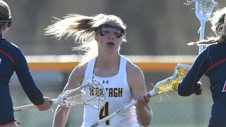 Madison Taylor #4 of Wantagh, center, gets pressured by South...