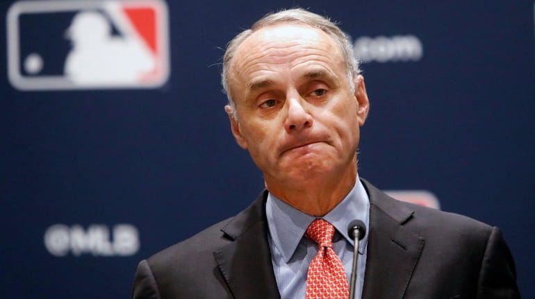 Baseball commissioner Rob Manfred pauses while speaking to the media...