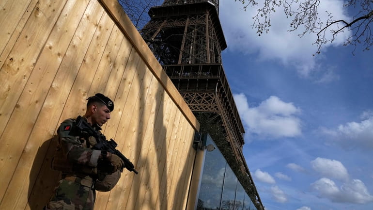 A soldier patrols at the Eiffel Tower, Monday, March 25,...