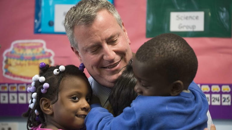 New York City Mayor Bill de Blasio receives hugs after...
