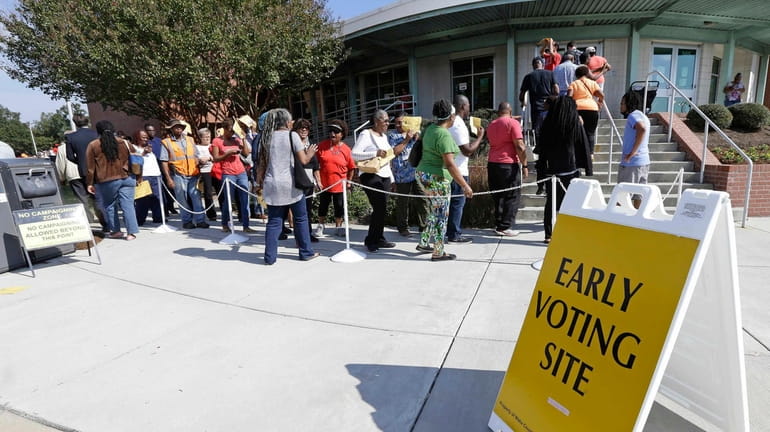 Voters line up Thursday, Oct. 20, 2016, during early voting...