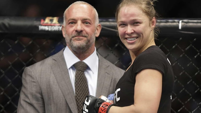 Ronda Rousey, right, smiles with UFC owner Lorenzo Fertitta following...