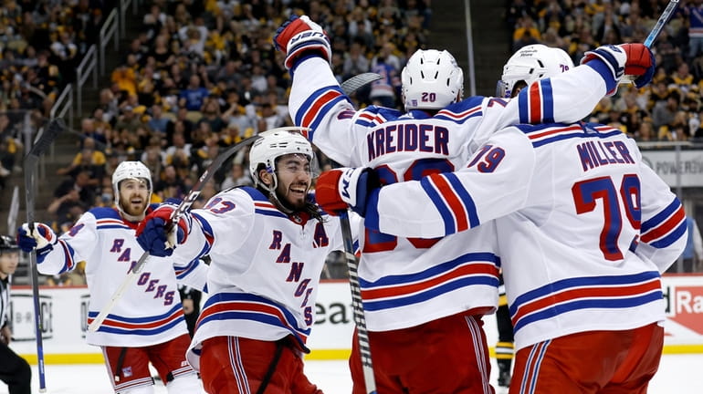 Chris Kreider #20 of the Rangers is congratulated by his teammates...
