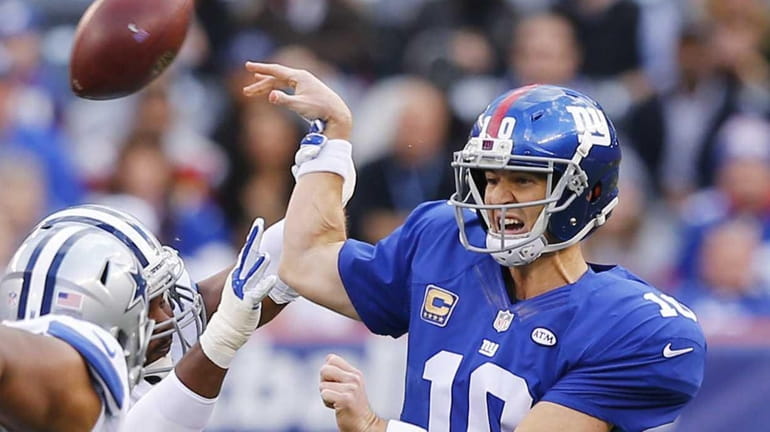 Eli Manning of the New York Giants has the ball...