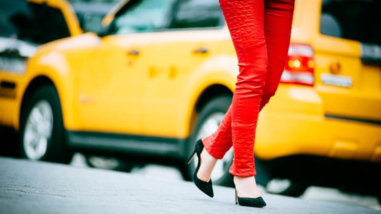 A woman in front of a cab.