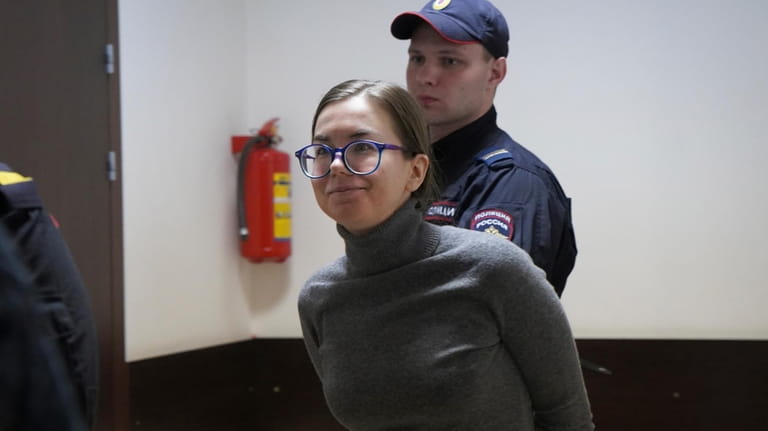 Viktoria Petrova is escorted by police for a hearing in...