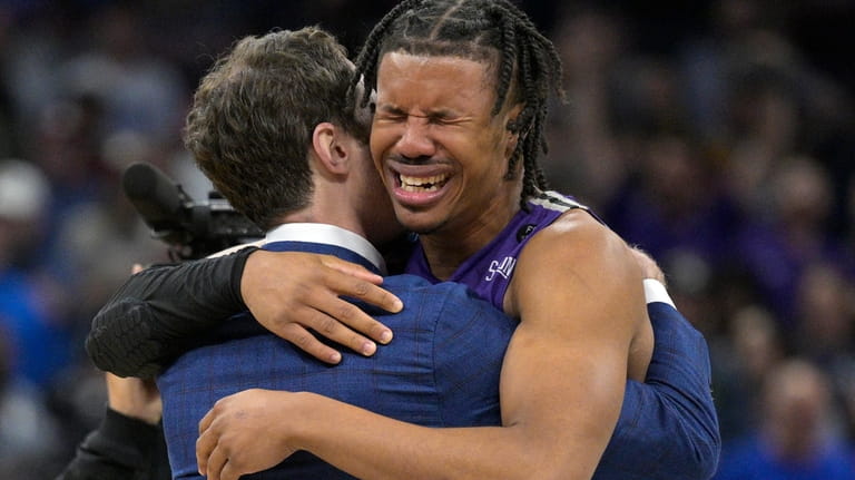 Furman guard Mike Bothwell, right, gets emotional after their win...